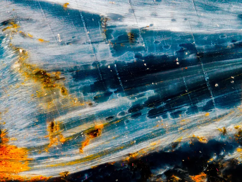 Chatoyant blue tiger's eye mineral surface at 5x magnification